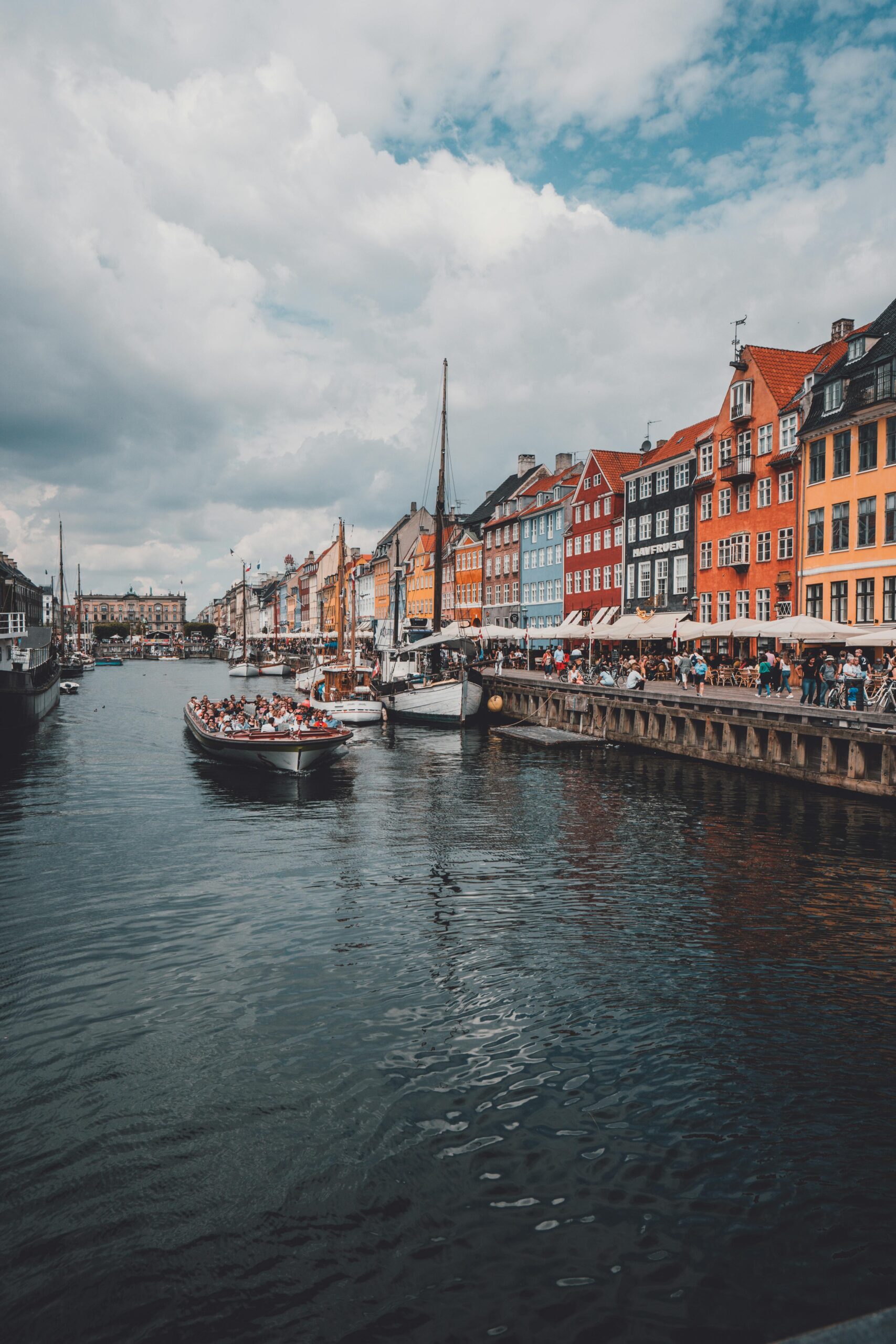 Vibrant view of Nyhavn with colorful buildings and a canal in Copenhagen, Denmark.